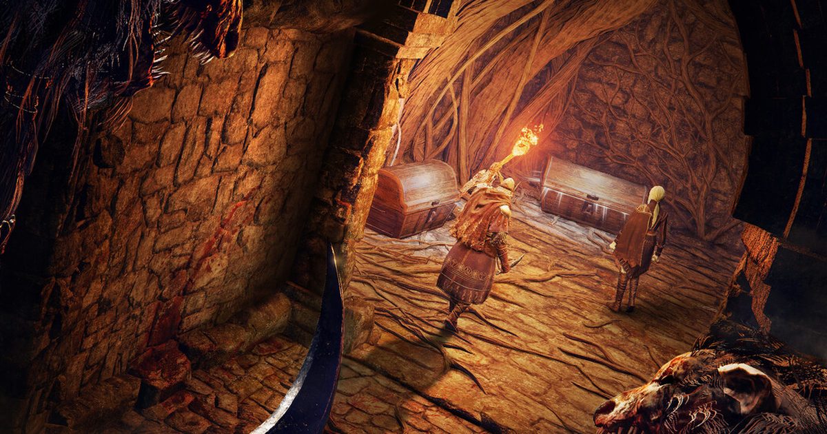 Two players, one holding a torch, approaching treasure chests in a torchlit stone chamber