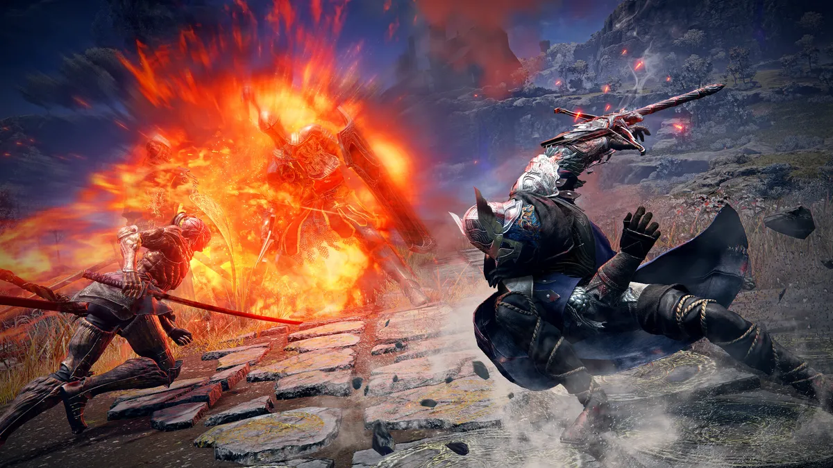 Two fighters on a stone floor, one caught in a fiery explosion